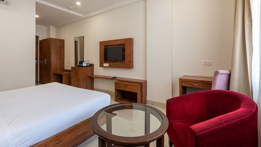Premium room featuring a TV, round tea table, and a wardrobe at DLS The Classio